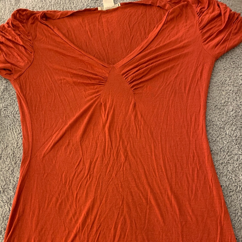 Orange tight fitting shirt
